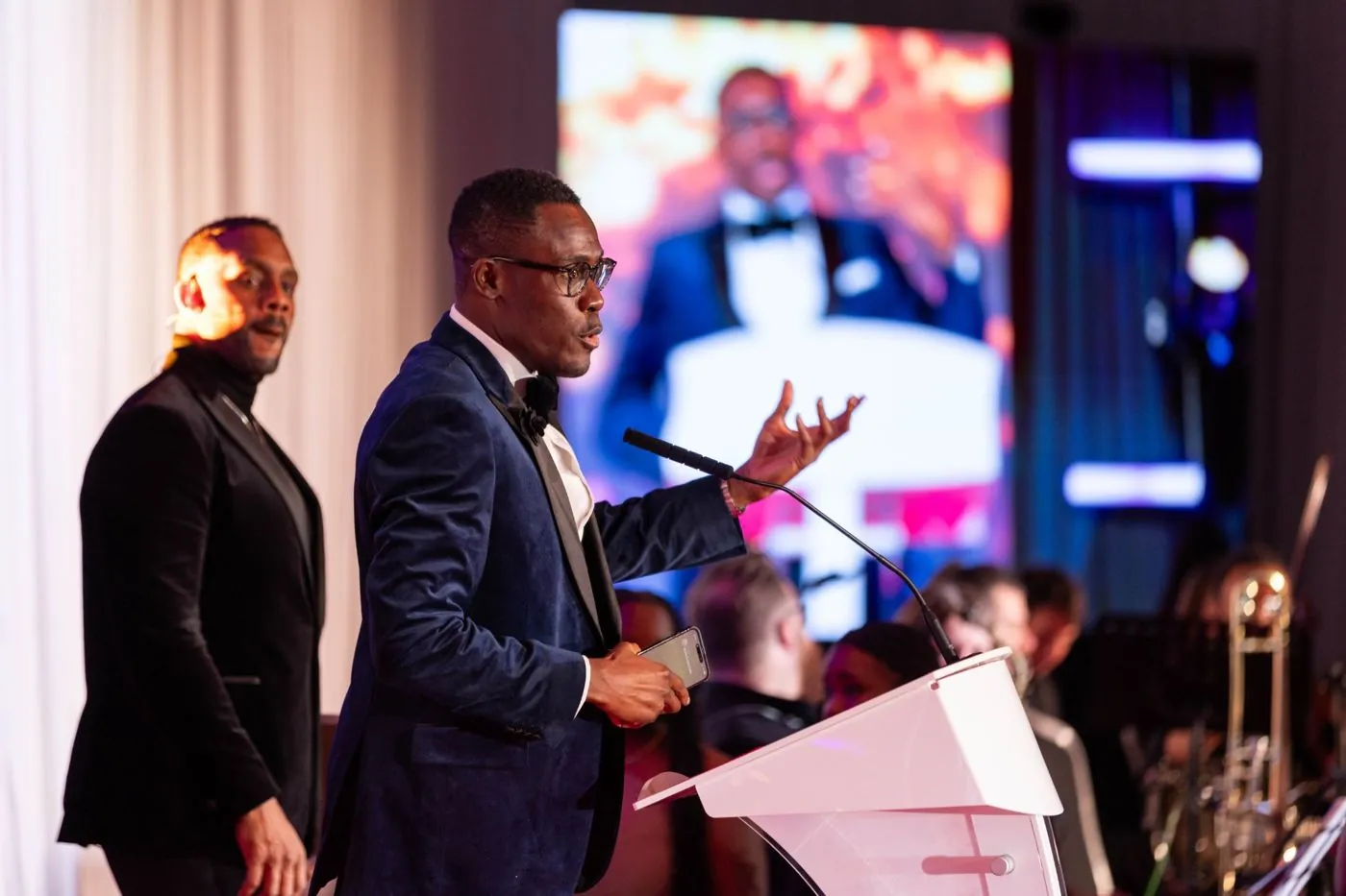 Peter speaking on stage at an awards event